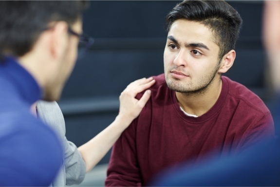 troubled man listening to another man talk